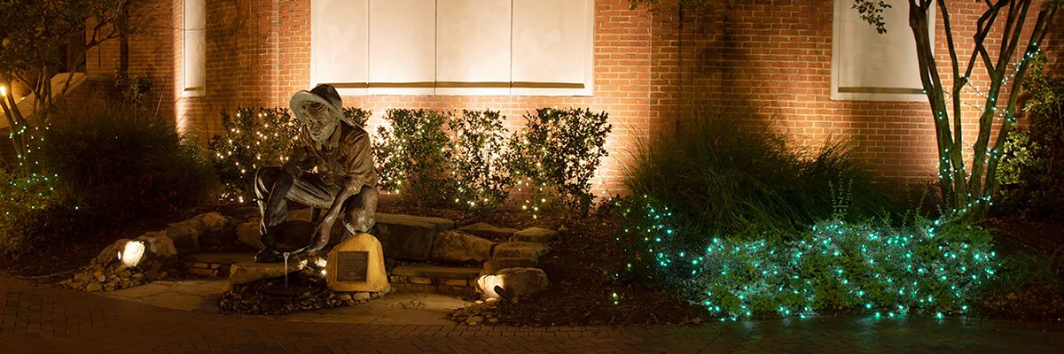 Miner statue at night with soft green lighting